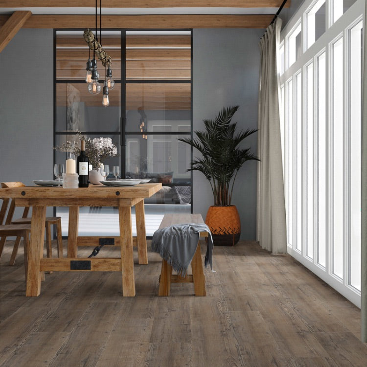 donker grijs bruin vloer met brede planken in een natuurlijke houtstructuur in een moderne eetkamer met houten tafel en bankje naast grote ramen en grijze muur