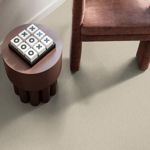 Beige tegelvloer met fijne, gelijkmatige structuur en lichte korrelige uitstraling zonder zichtbaar patroon.