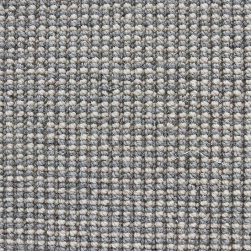 grijs beige tapijt met fijn geweven bolletjesstructuur in een vlak patroon